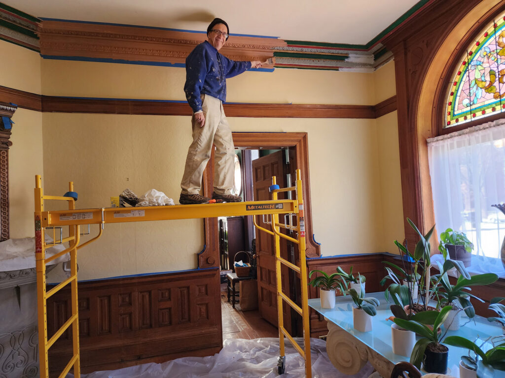 Architect Ward Bucher painting cornice